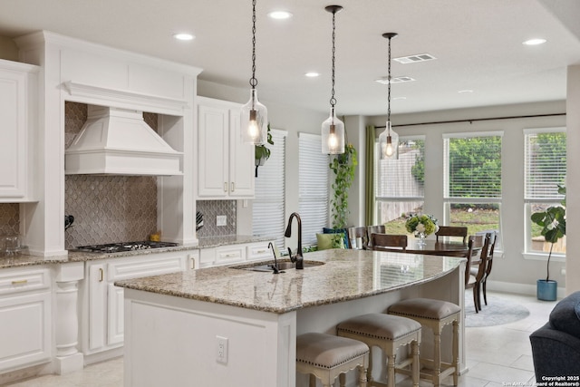 25723 Coreopsis, San Antonio, TX 78261 - kitchen with premium range hood, a sink, decorative backsplash, recessed lighting, and a center island with sink