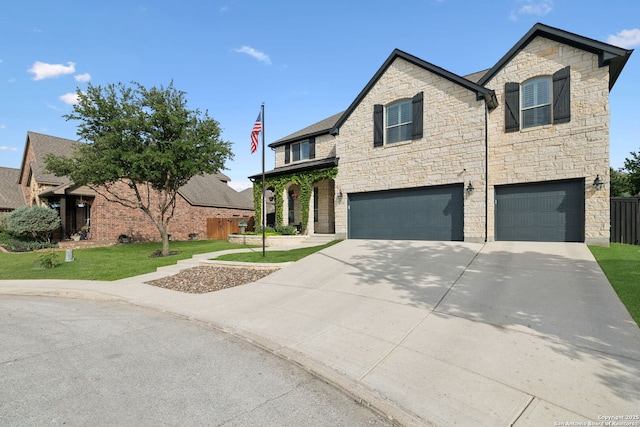 25723 Coreopsis, San Antonio, TX 78261 - view of front of house featuring an attached garage, stone siding, concrete driveway, and a front yard