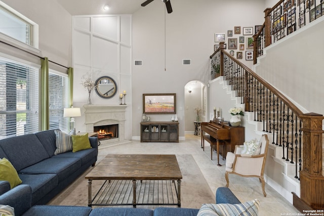 25723 Coreopsis, San Antonio, TX 78261 - living area with a towering ceiling, a ceiling fan, stairs, a high end fireplace, and light tile patterned flooring