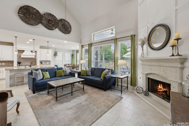 25723 Coreopsis, San Antonio, TX 78261 - living room featuring a high end fireplace, high vaulted ceiling, and light tile patterned floors
