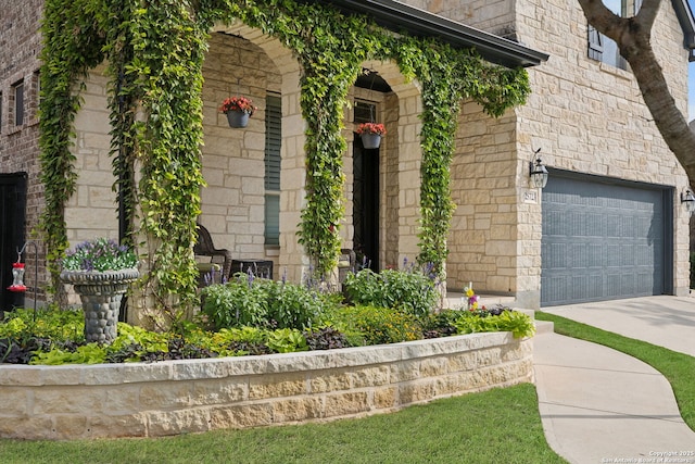 25723 Coreopsis, San Antonio, TX 78261 - view of exterior entry featuring concrete driveway, an attached garage, and stone siding