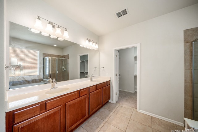 1014 Windy Pond, San Antonio, TX 78260 - full bathroom featuring a walk in closet, a shower stall, tile patterned flooring, double vanity, and baseboards