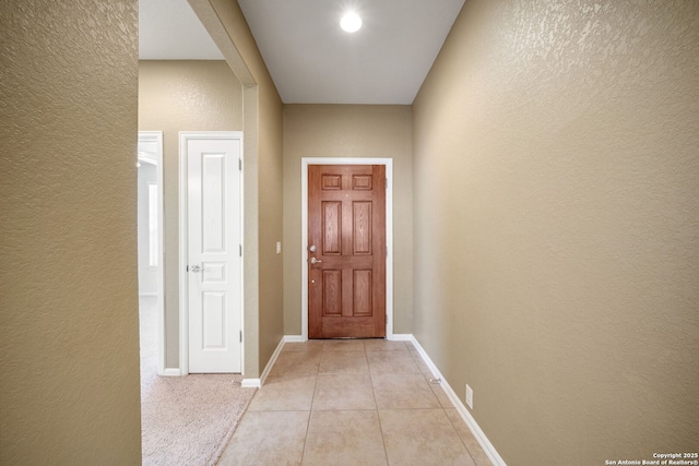 1014 Windy Pond, San Antonio, TX 78260 - doorway with a textured wall, light tile patterned floors, and baseboards