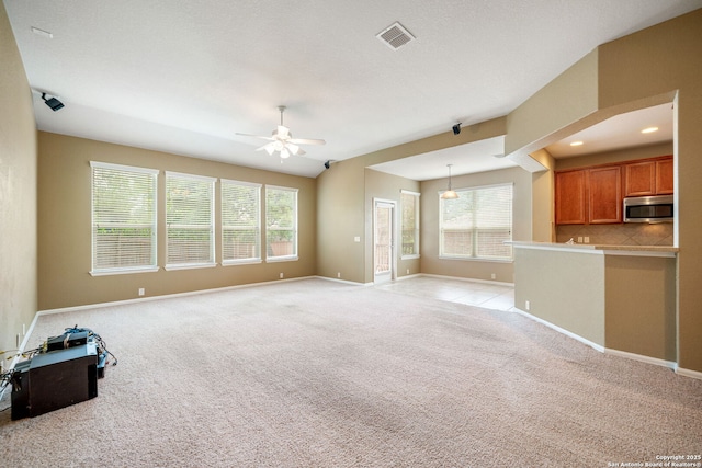 1014 Windy Pond, San Antonio, TX 78260 - unfurnished living room featuring healthy amount of natural light, ceiling fan, baseboards, and light carpet