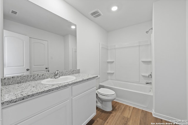 11502 Bald Eagle Hts, San Antonio, TX 78223 - bathroom with vanity, wood finished floors, toilet, and shower / tub combination