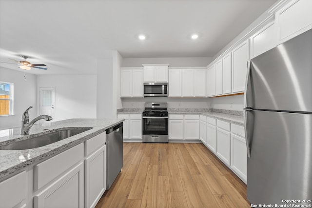 11502 Bald Eagle Hts, San Antonio, TX 78223 - kitchen featuring appliances with stainless steel finishes, a sink, white cabinetry, recessed lighting, and a ceiling fan