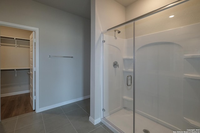 10310 Tule Creek Frk, San Antonio, TX 78252 - bathroom with a shower stall, a walk in closet, baseboards, and tile patterned flooring