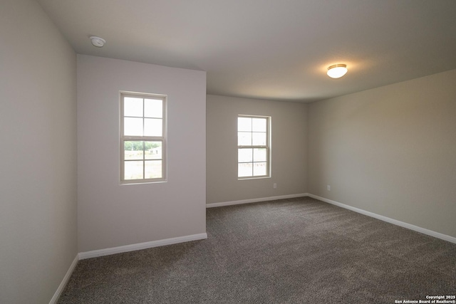 10310 Tule Creek Frk, San Antonio, TX 78252 - unfurnished room featuring healthy amount of natural light, dark carpet, and baseboards