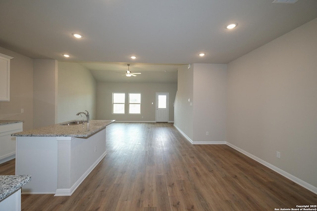 10310 Tule Creek Frk, San Antonio, TX 78252 - kitchen featuring a sink, wood finished floors, ceiling fan, white cabinets, and baseboards