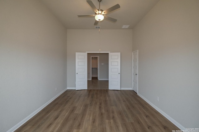 10310 Tule Creek Frk, San Antonio, TX 78252 - empty room featuring ceiling fan, wood finished floors, high vaulted ceiling, and baseboards