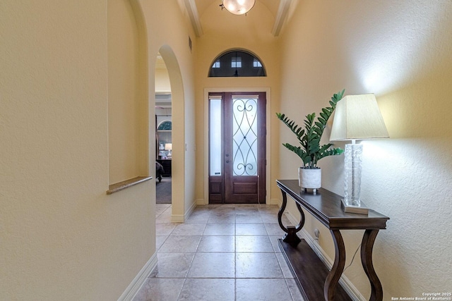 16006 N Huebner Blf, San Antonio, TX 78248 - foyer featuring arched walkways, a textured wall, and baseboards