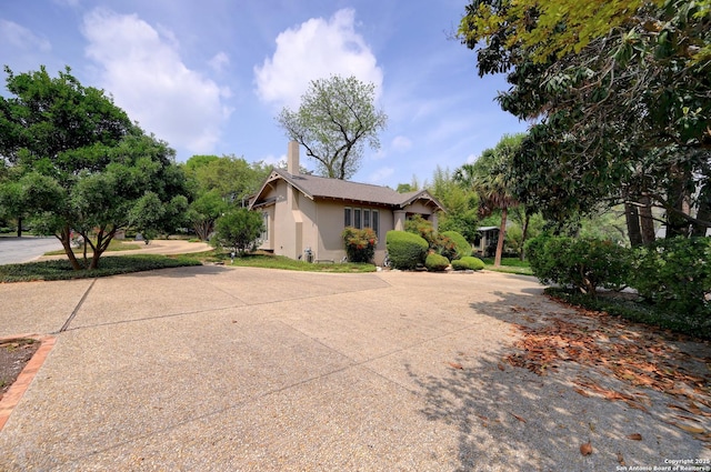 106 Mayflower, Alamo Heights, TX 78209 - view of property exterior with stucco siding and a chimney