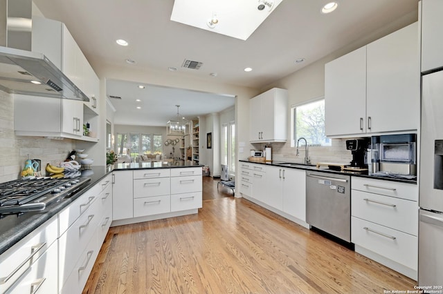 106 Mayflower, Alamo Heights, TX 78209 - kitchen featuring appliances with stainless steel finishes, a sink, dark countertops, plenty of natural light, and recessed lighting
