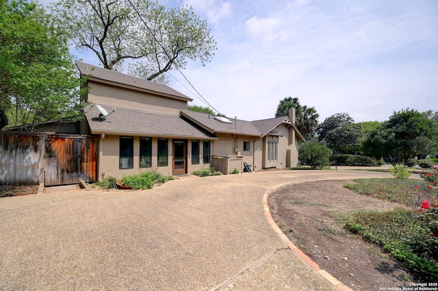 106 Mayflower, Alamo Heights, TX 78209 - view of front of property featuring stucco siding, a shingled roof, and a chimney