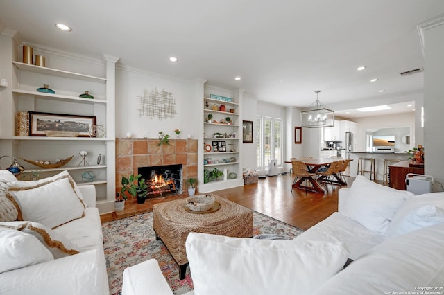 106 Mayflower, Alamo Heights, TX 78209 - living area with wood finished floors, a fireplace, recessed lighting, a chandelier, and built in shelves