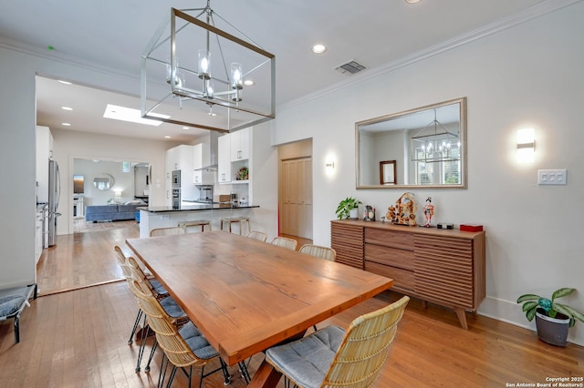 106 Mayflower, Alamo Heights, TX 78209 - dining room with a chandelier, crown molding, light wood-style floors, recessed lighting, and baseboards