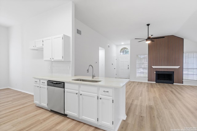 6610 Quail Lk, San Antonio, TX 78244 - kitchen with stainless steel dishwasher, a sink, a ceiling fan, light wood finished floors, and white cabinetry
