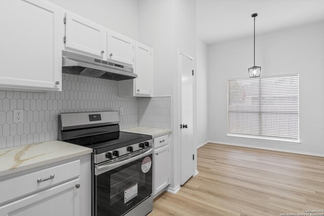 6610 Quail Lk, San Antonio, TX 78244 - kitchen with stainless steel electric range, under cabinet range hood, white cabinets, decorative backsplash, and light wood-type flooring