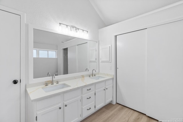 6610 Quail Lk, San Antonio, TX 78244 - bathroom with vaulted ceiling, double vanity, and wood finished floors
