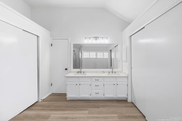 6610 Quail Lk, San Antonio, TX 78244 - bathroom with double vanity, lofted ceiling, and wood finished floors