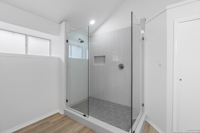 6610 Quail Lk, San Antonio, TX 78244 - full bathroom featuring wood finished floors, walk in shower, vaulted ceiling, and baseboards