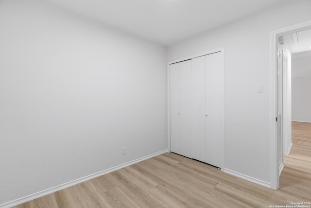 6610 Quail Lk, San Antonio, TX 78244 - unfurnished bedroom with light wood-style floors, baseboards, and a closet