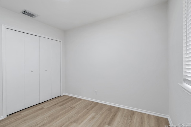 6610 Quail Lk, San Antonio, TX 78244 - unfurnished bedroom featuring light wood finished floors, a closet, and baseboards