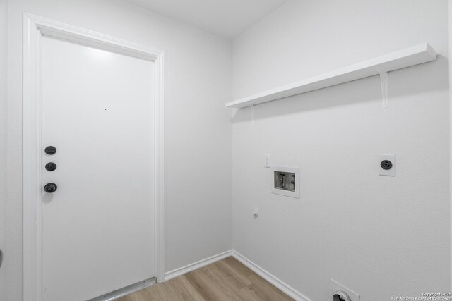6610 Quail Lk, San Antonio, TX 78244 - washroom with hookup for a washing machine, light wood finished floors, hookup for an electric dryer, hookup for a gas dryer, and baseboards