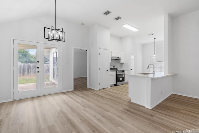 6610 Quail Lk, San Antonio, TX 78244 - kitchen featuring stainless steel range, a sink, under cabinet range hood, white cabinets, and light wood finished floors