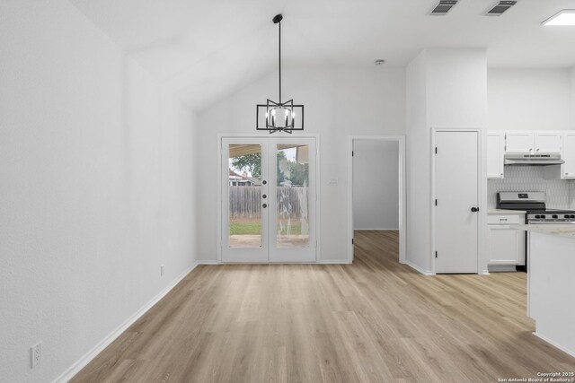 6610 Quail Lk, San Antonio, TX 78244 - unfurnished dining area featuring light wood finished floors, a chandelier, high vaulted ceiling, baseboards, and french doors