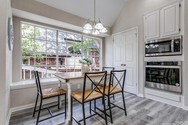 13019 Rambling Oak, San Antonio, TX 78232 - dining room with vaulted ceiling, light wood-style flooring, a chandelier, and baseboards