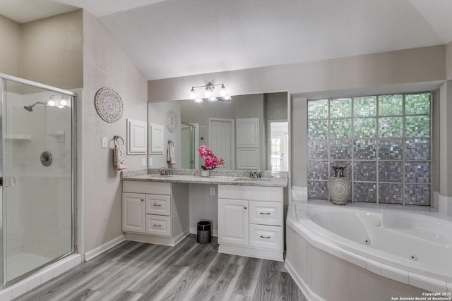 13019 Rambling Oak, San Antonio, TX 78232 - full bathroom featuring a shower stall, a whirlpool tub, double vanity, wood finished floors, and lofted ceiling