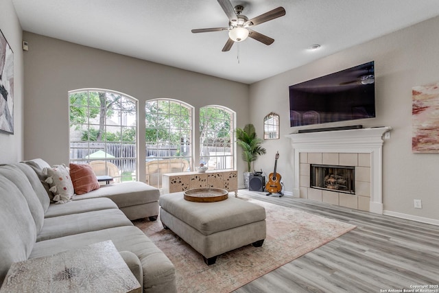 13019 Rambling Oak, San Antonio, TX 78232 - living area with wood finished floors, ceiling fan, a fireplace, and baseboards