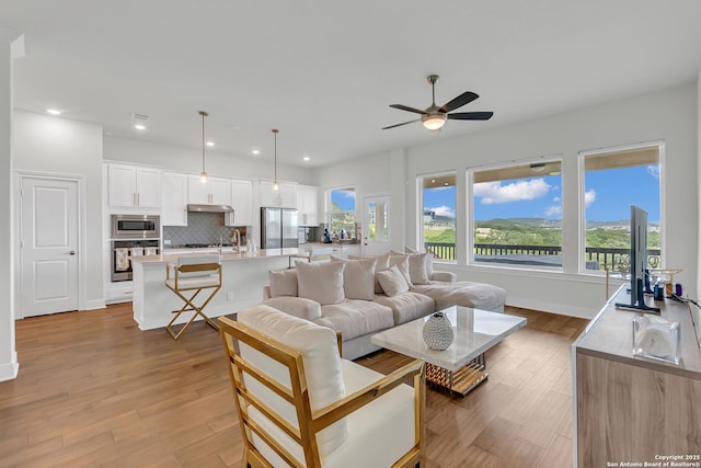 6827 Bella Verso, San Antonio, TX 78256 - living room featuring a ceiling fan, recessed lighting, light wood finished floors, and baseboards