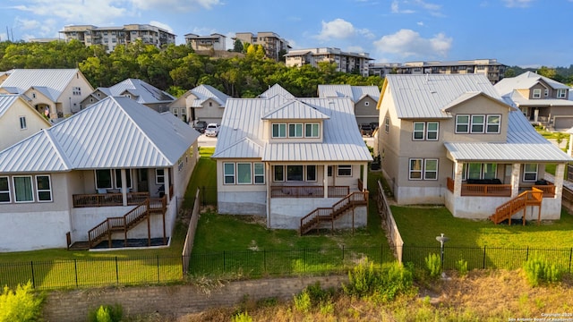 6827 Bella Verso, San Antonio, TX 78256 - rear view of house with stairway, a residential view, metal roof, a standing seam roof, and stucco siding