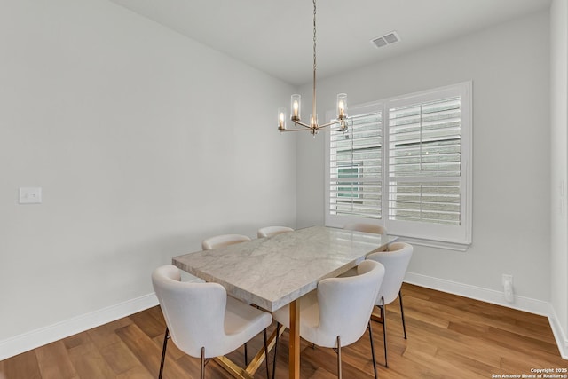 6827 Bella Verso, San Antonio, TX 78256 - dining space with a chandelier, baseboards, and wood finished floors