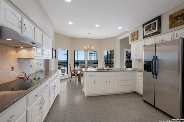 14706 War Admiral, San Antonio, TX 78248 - kitchen with stainless steel refrigerator with ice dispenser, a sink, black electric stovetop, a peninsula, and under cabinet range hood