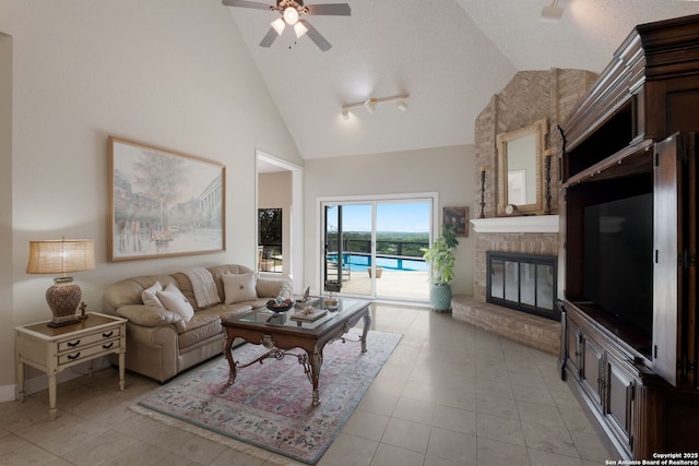 14706 War Admiral, San Antonio, TX 78248 - living area featuring a ceiling fan, high vaulted ceiling, a brick fireplace, light tile patterned floors, and track lighting