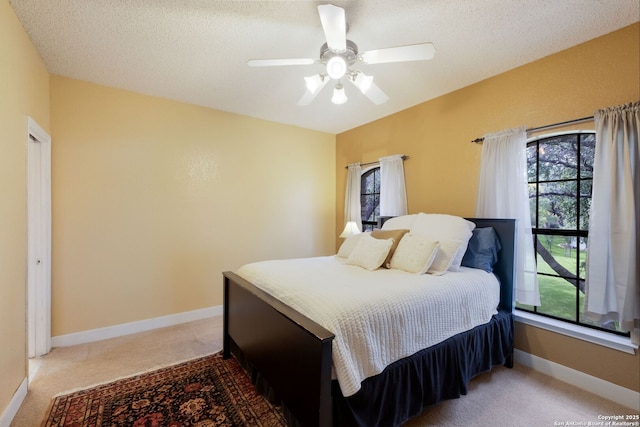 14706 War Admiral, San Antonio, TX 78248 - carpeted bedroom with multiple windows, ceiling fan, baseboards, and a textured ceiling