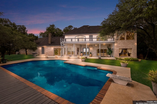 14706 War Admiral, San Antonio, TX 78248 - pool at dusk featuring a patio area, a lawn, and an outdoor pool