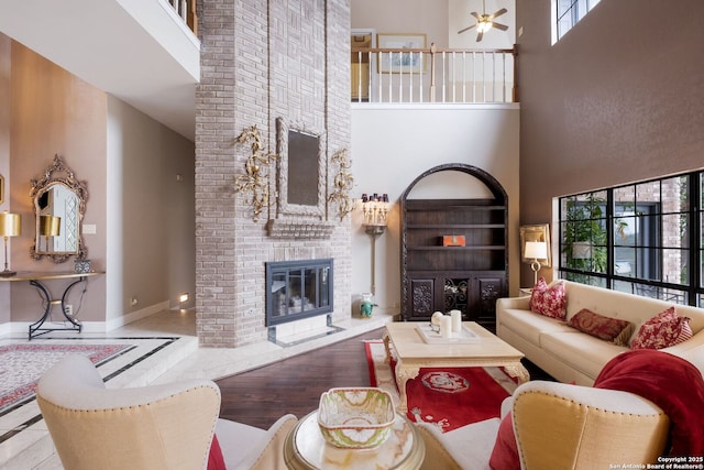 14706 War Admiral, San Antonio, TX 78248 - living area with a towering ceiling, a fireplace, baseboards, a ceiling fan, and inlaid floor details