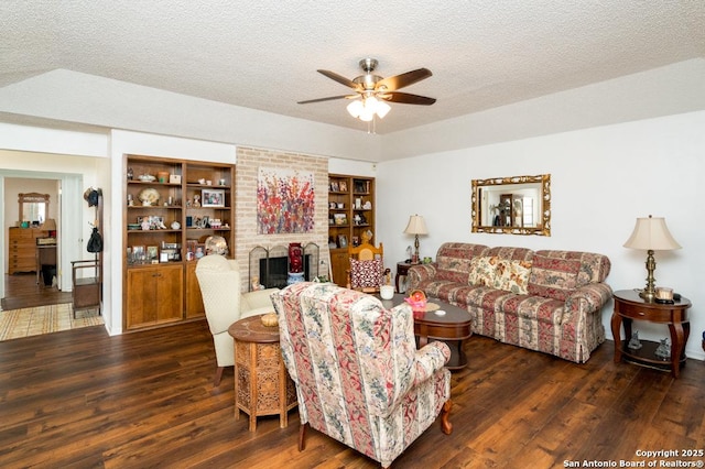 5823 Archwood, San Antonio, TX 78239 - living area with a ceiling fan, wood finished floors, a fireplace, and a textured ceiling