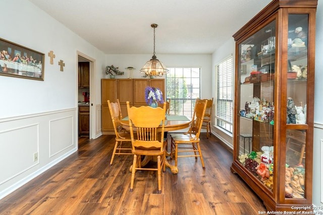5823 Archwood, San Antonio, TX 78239 - dining space with a chandelier, dark wood-style floors, and a wainscoted wall