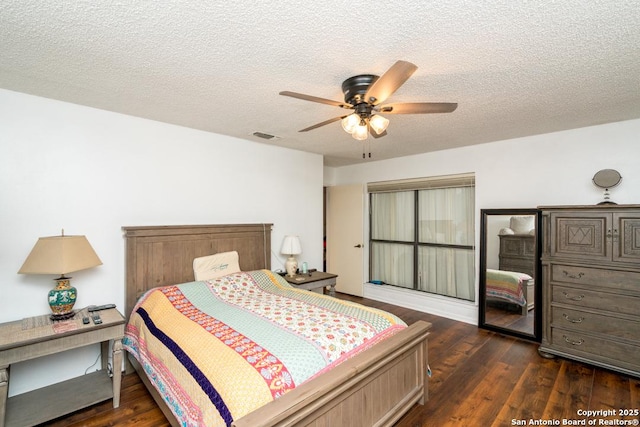 5823 Archwood, San Antonio, TX 78239 - bedroom with dark wood-style flooring, a textured ceiling, and a ceiling fan