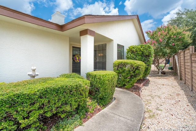 5823 Archwood, San Antonio, TX 78239 - view of exterior entry featuring stucco siding and a chimney