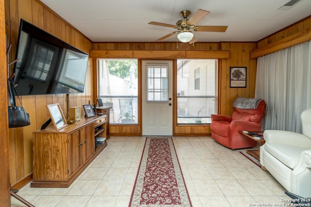 5823 Archwood, San Antonio, TX 78239 - entryway featuring wooden walls, a ceiling fan, light tile patterned flooring, and ornamental molding