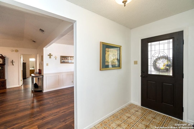5823 Archwood, San Antonio, TX 78239 - entryway with wood finished floors, vaulted ceiling, and a textured ceiling