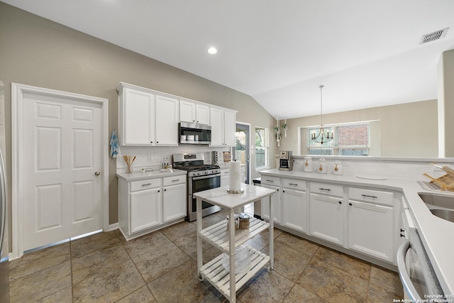 13014 Essen, Helotes, TX 78023 - kitchen with appliances with stainless steel finishes, backsplash, lofted ceiling, a chandelier, and white cabinets