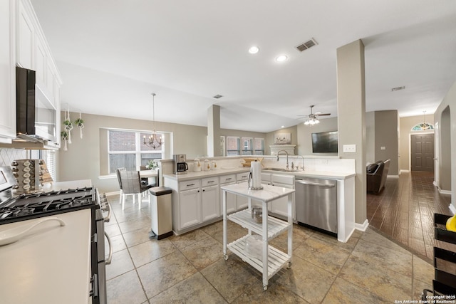 13014 Essen, Helotes, TX 78023 - kitchen with appliances with stainless steel finishes, backsplash, a sink, white cabinets, and baseboards