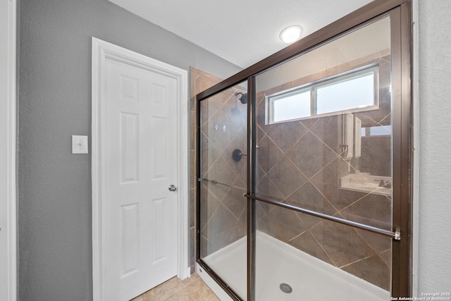 13014 Essen, Helotes, TX 78023 - full bath featuring a shower stall, tile patterned flooring, and a textured wall